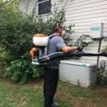 a tech performing mosquito pest services