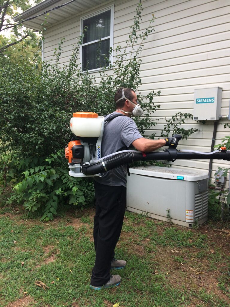 a tech performing mosquito pest services