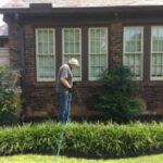 commercial applicator applying exterior spray treatment